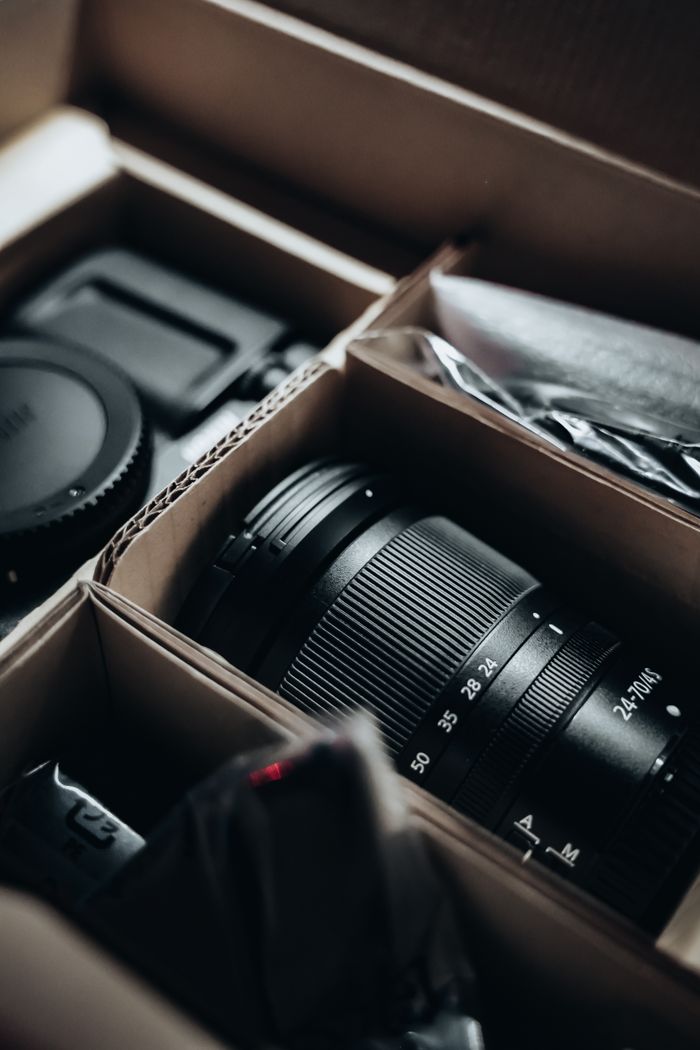 About Unboxing a new camera lens and accessories with close-up view, perfect for photographers.
